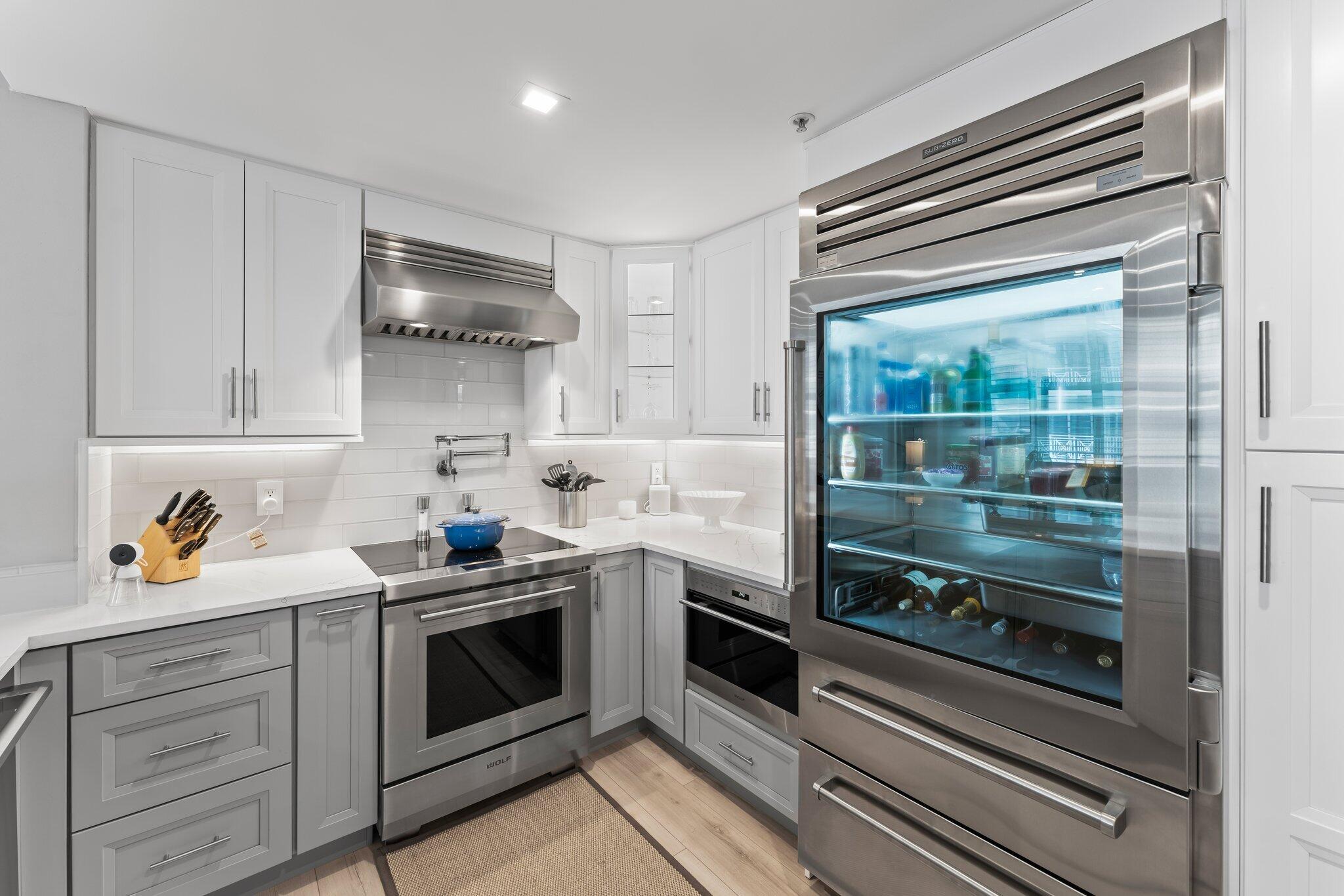 255 Evernia Street, Unit 1502 West Palm Beach, FL 33401 - Photo 6 of 40 a kitchen with stainless steel appliances a stove and cabinets