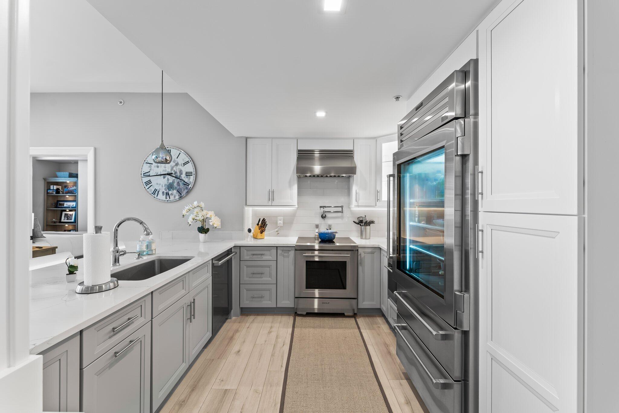 255 Evernia Street, Unit 1502 West Palm Beach, FL 33401 - Photo 7 of 40 a kitchen with cabinets and stainless steel appliances
