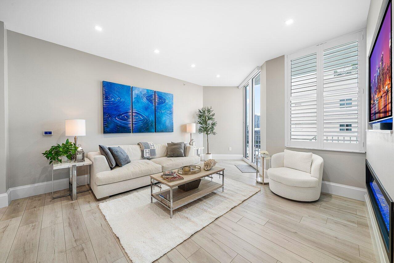 255 Evernia Street, Unit 1502 West Palm Beach, FL 33401 - Photo 10 of 40 a living room with furniture and wooden floor