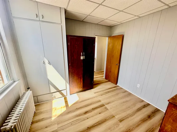a bedroom with a bed and a mirror