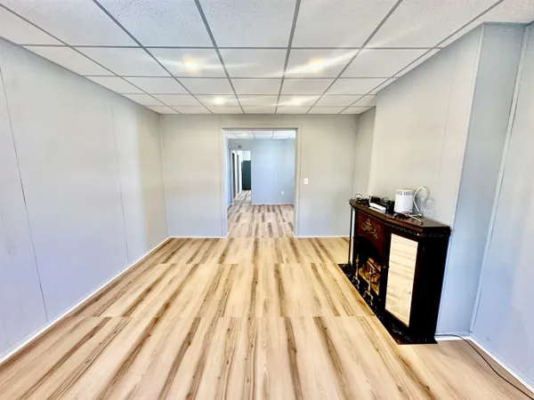 a view of a bedroom with wooden floor