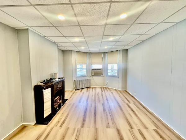 a view of a room with wooden floor