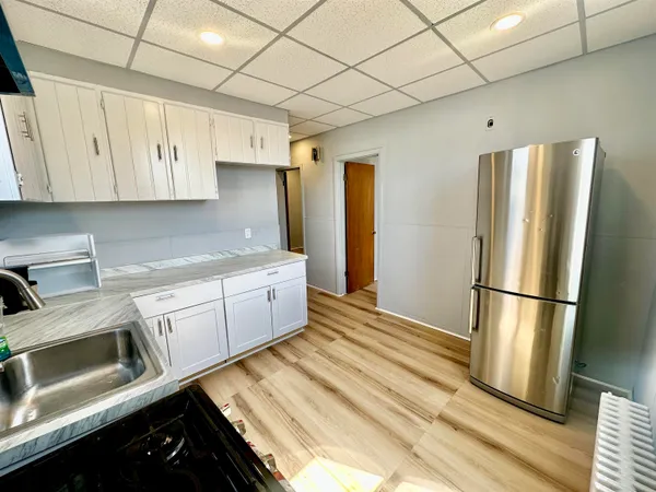a kitchen with stainless steel appliances a refrigerator sink and cabinets