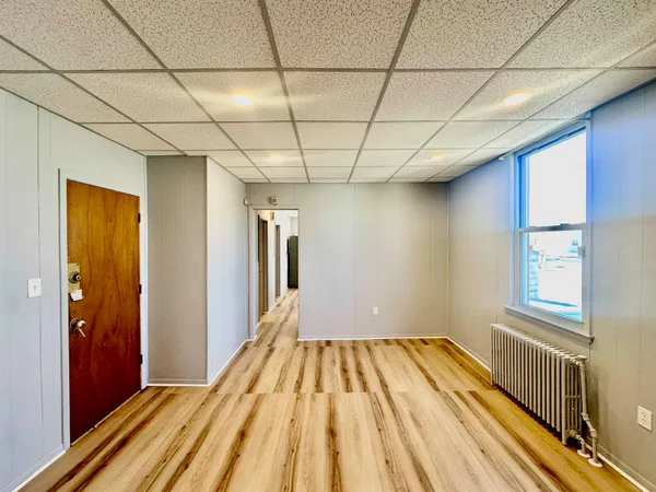 a view of a room with wooden floor