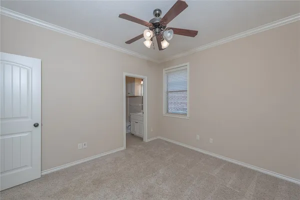 an empty room with a window and a ceiling fan