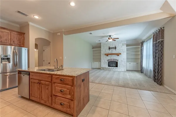 a view of a kitchen with a sink and a refrigerator
