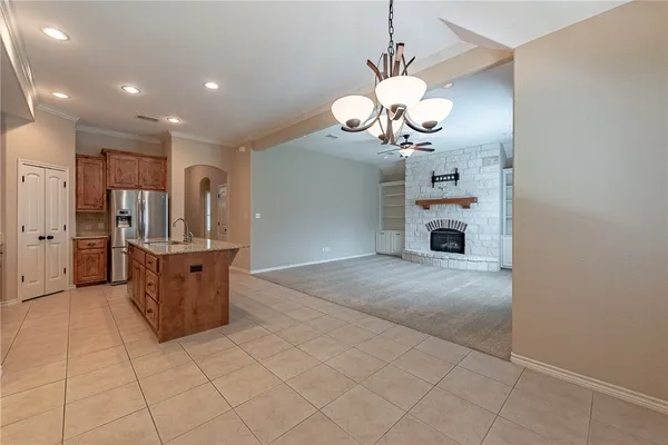 a view of a kitchen with a sink and chandelier