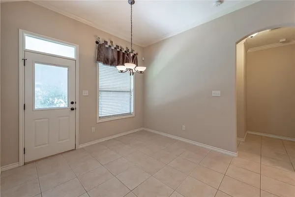 a view of a room with a chandelier fan and windows