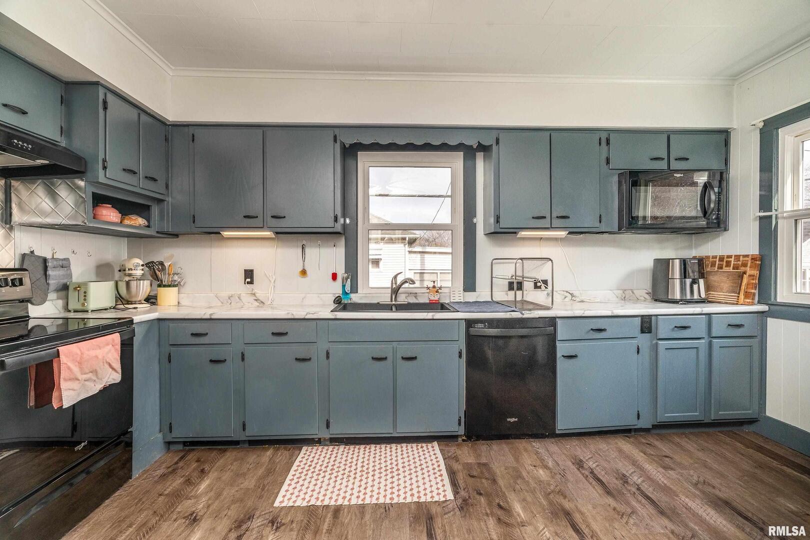 501 South Buchanan Street Marion, IL 62959 - Photo 11 of 32 a kitchen with stainless steel appliances granite countertop a sink stove and cabinets
