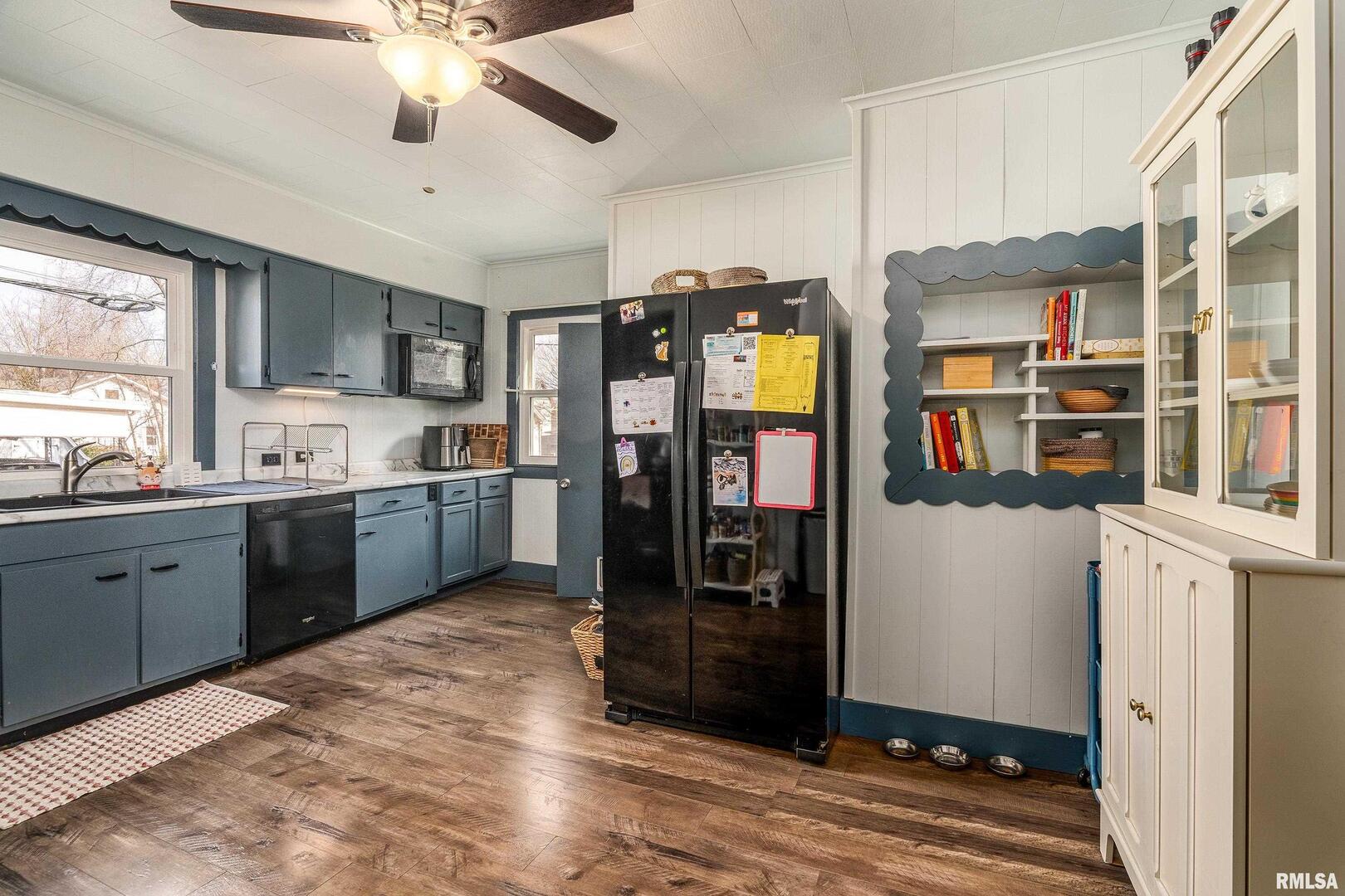 501 South Buchanan Street Marion, IL 62959 - Photo 10 of 32 a kitchen with stainless steel appliances kitchen island granite countertop a refrigerator and a sink