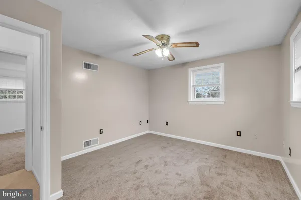 a view of empty room with ceiling fan