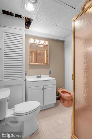 a bathroom with a toilet a sink and a mirror