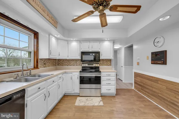 a kitchen with stainless steel appliances a stove sink and cabinets