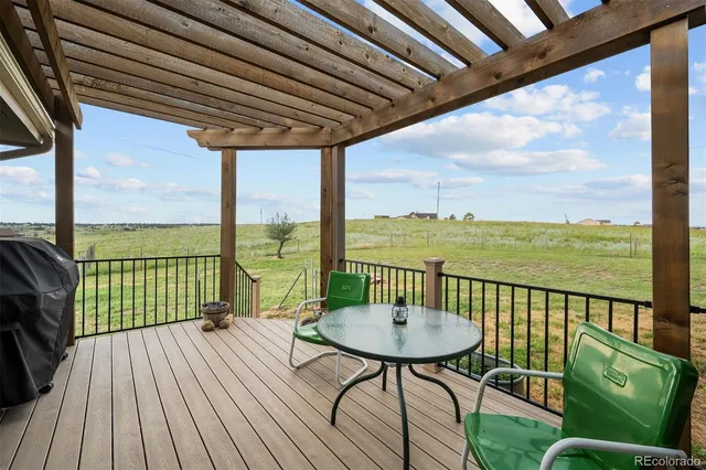 a view of a balcony with table and chairs