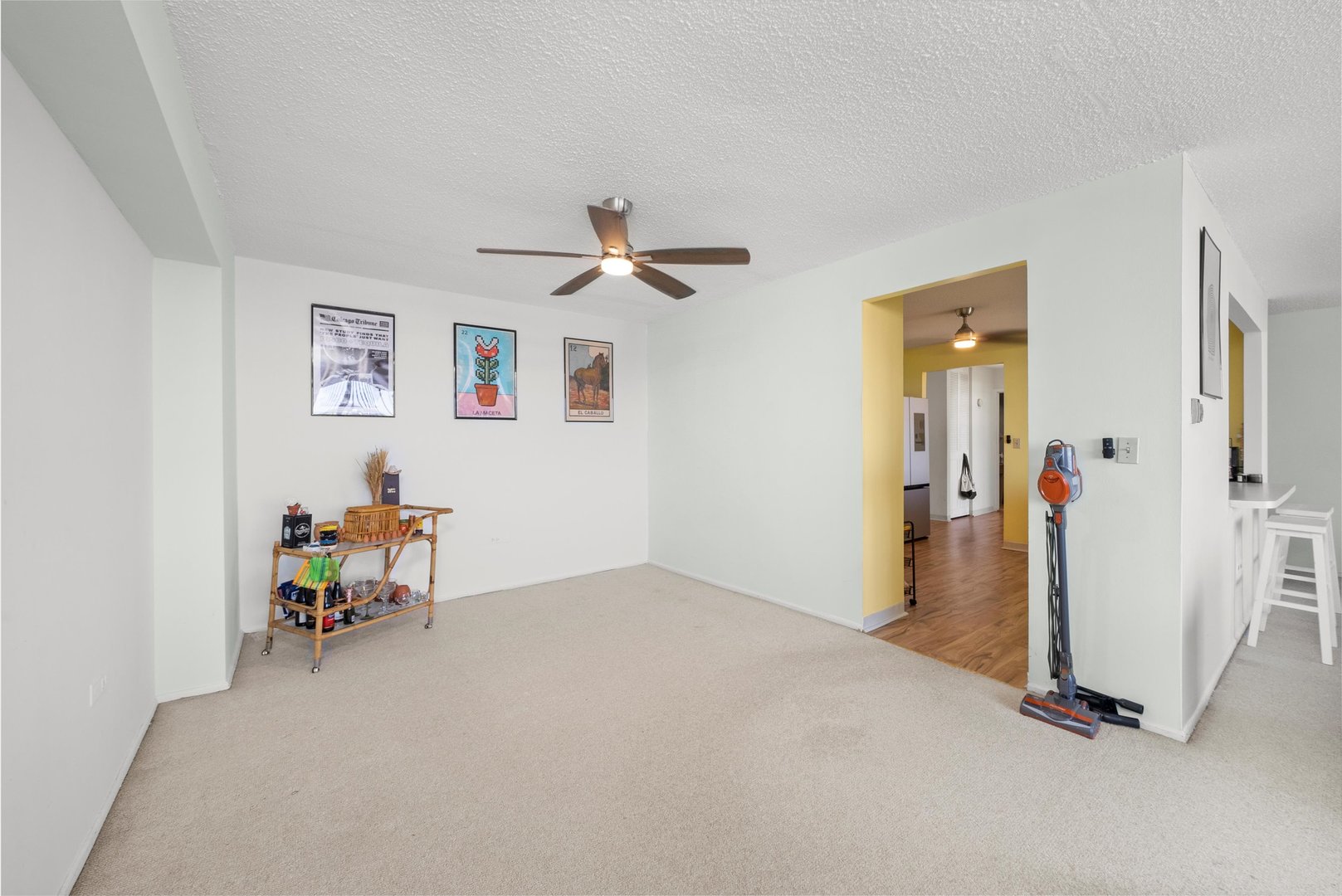 8815 West Golf Road, Unit 11C Niles, IL 60714 - Photo 12 of 31 a view of a hallway with a furniture and a ceiling fan