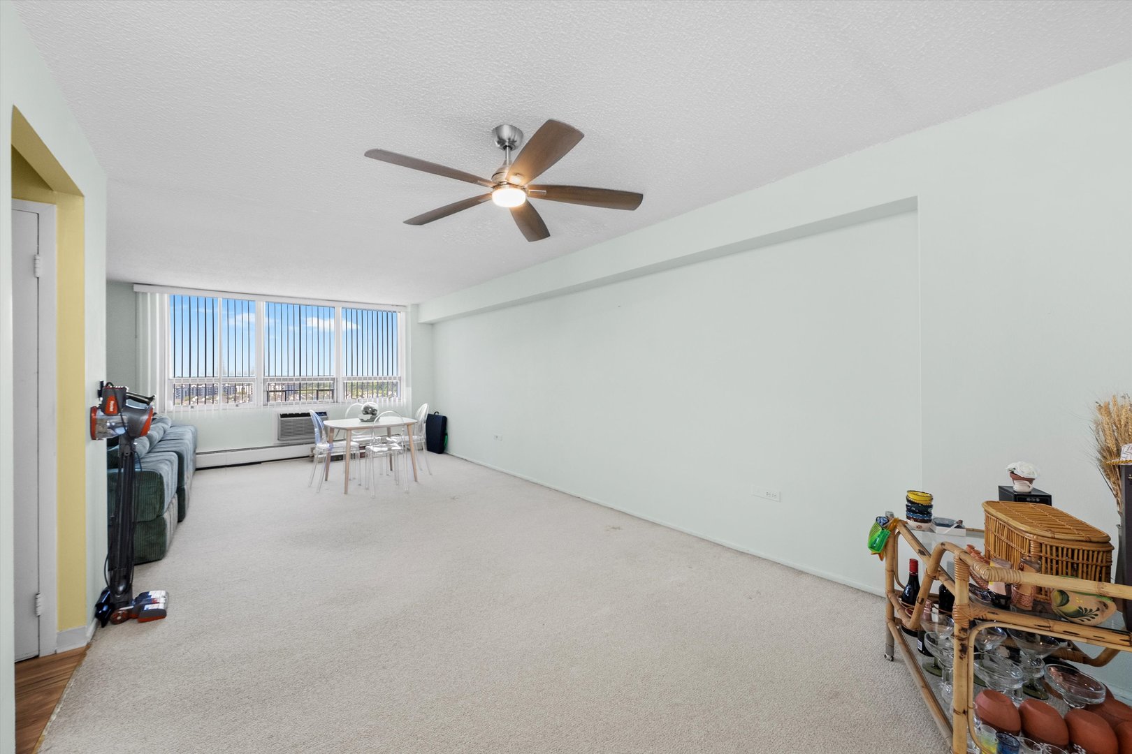 8815 West Golf Road, Unit 11C Niles, IL 60714 - Photo 13 of 31 a view of a livingroom with furniture and a ceiling fan