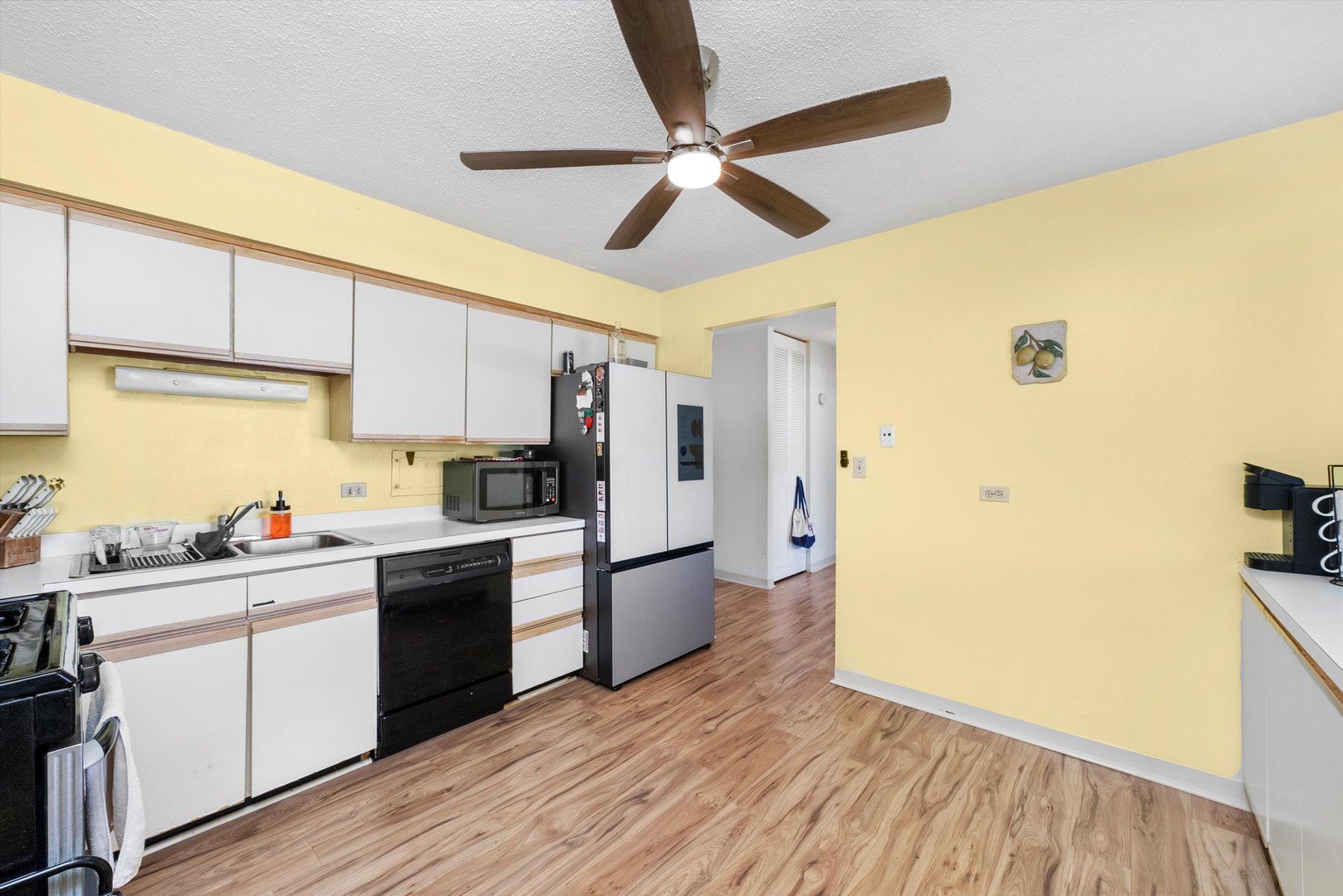 8815 West Golf Road, Unit 11C Niles, IL 60714 - Photo 15 of 31 a kitchen with a sink appliances cabinets and a counter space