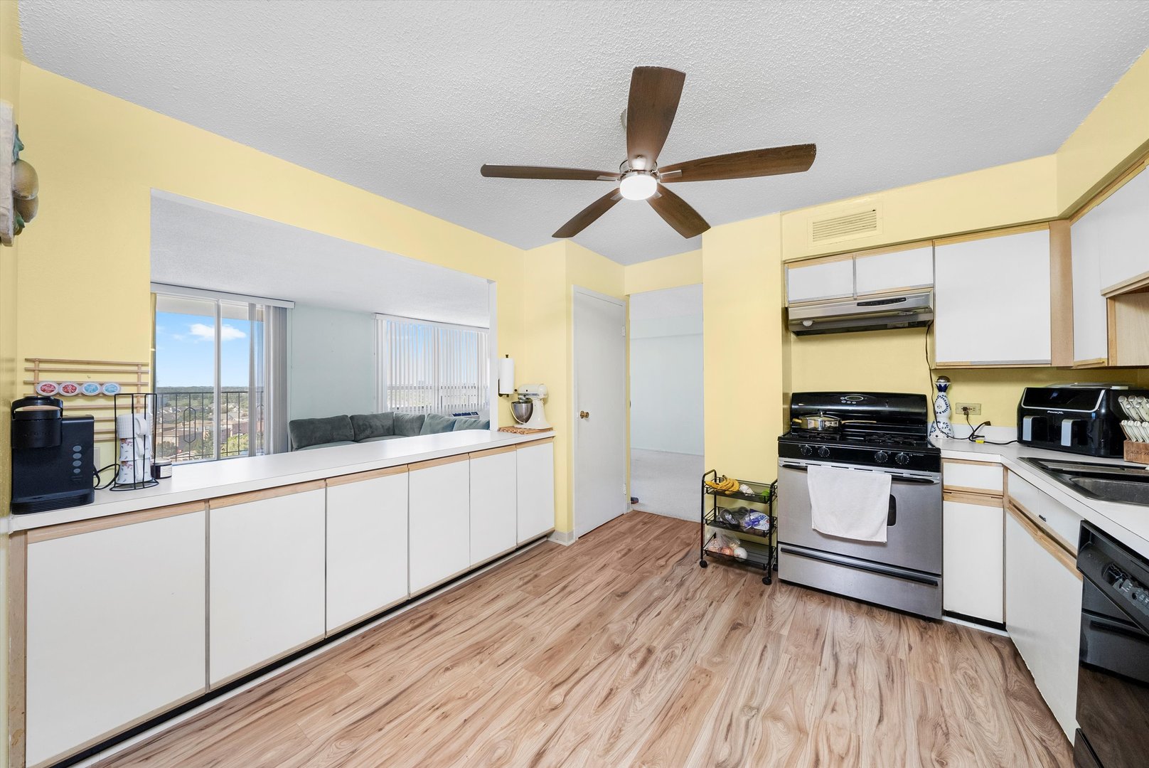 8815 West Golf Road, Unit 11C Niles, IL 60714 - Photo 17 of 31 a kitchen with stainless steel appliances a sink cabinets and wooden floor