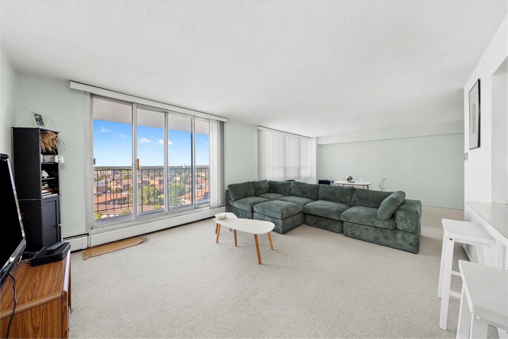 8815 West Golf Road, Unit 11C Niles, IL 60714 - Photo 4 of 31 a living room with furniture and a flat screen tv