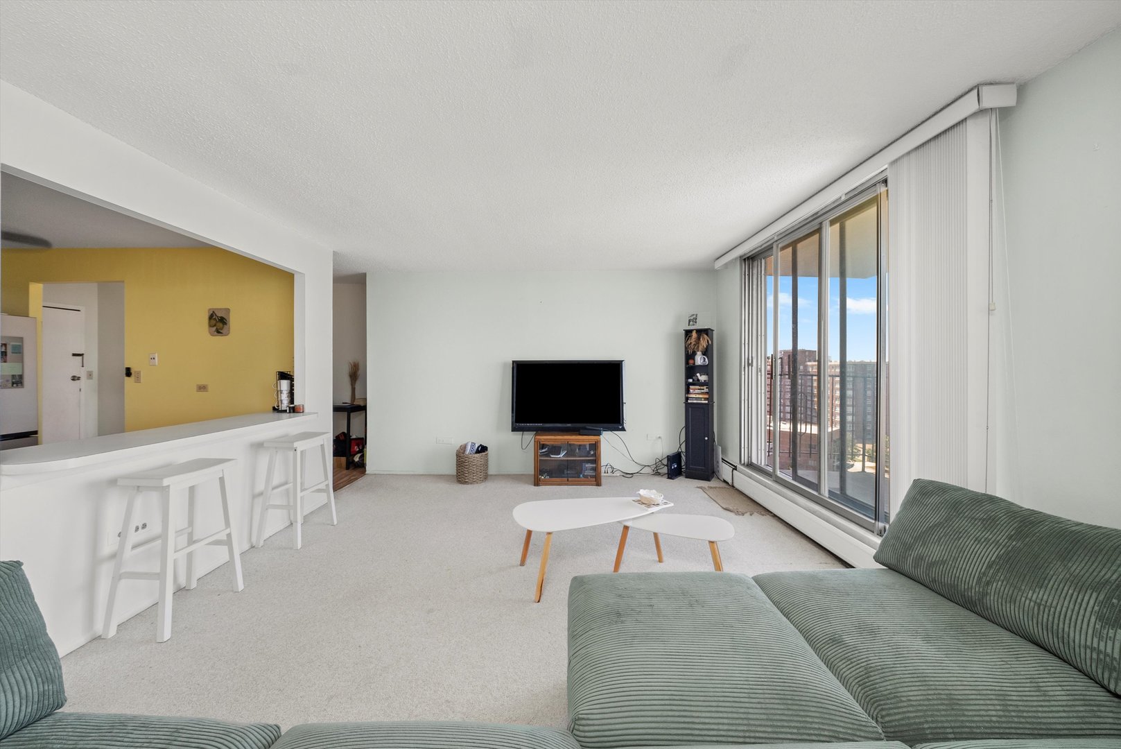 8815 West Golf Road, Unit 11C Niles, IL 60714 - Photo 7 of 31 a living room with furniture and a flat screen tv