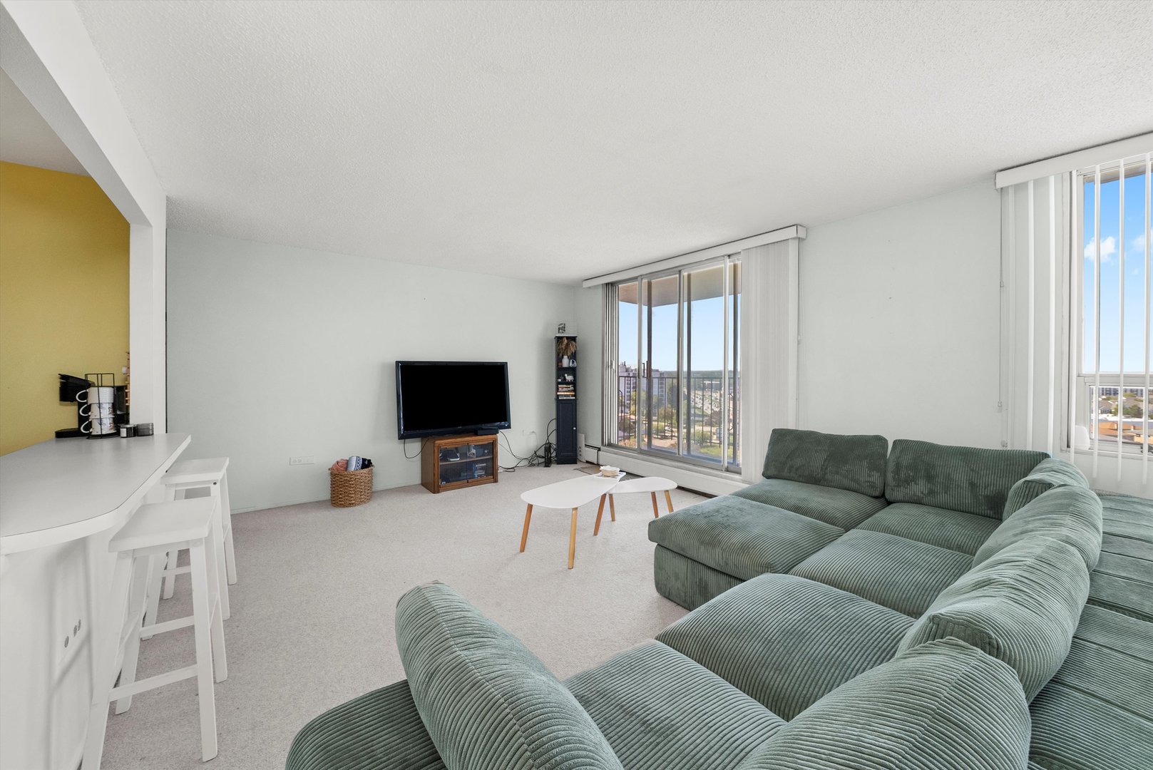 8815 West Golf Road, Unit 11C Niles, IL 60714 - Photo 8 of 31 a living room with furniture and a flat screen tv