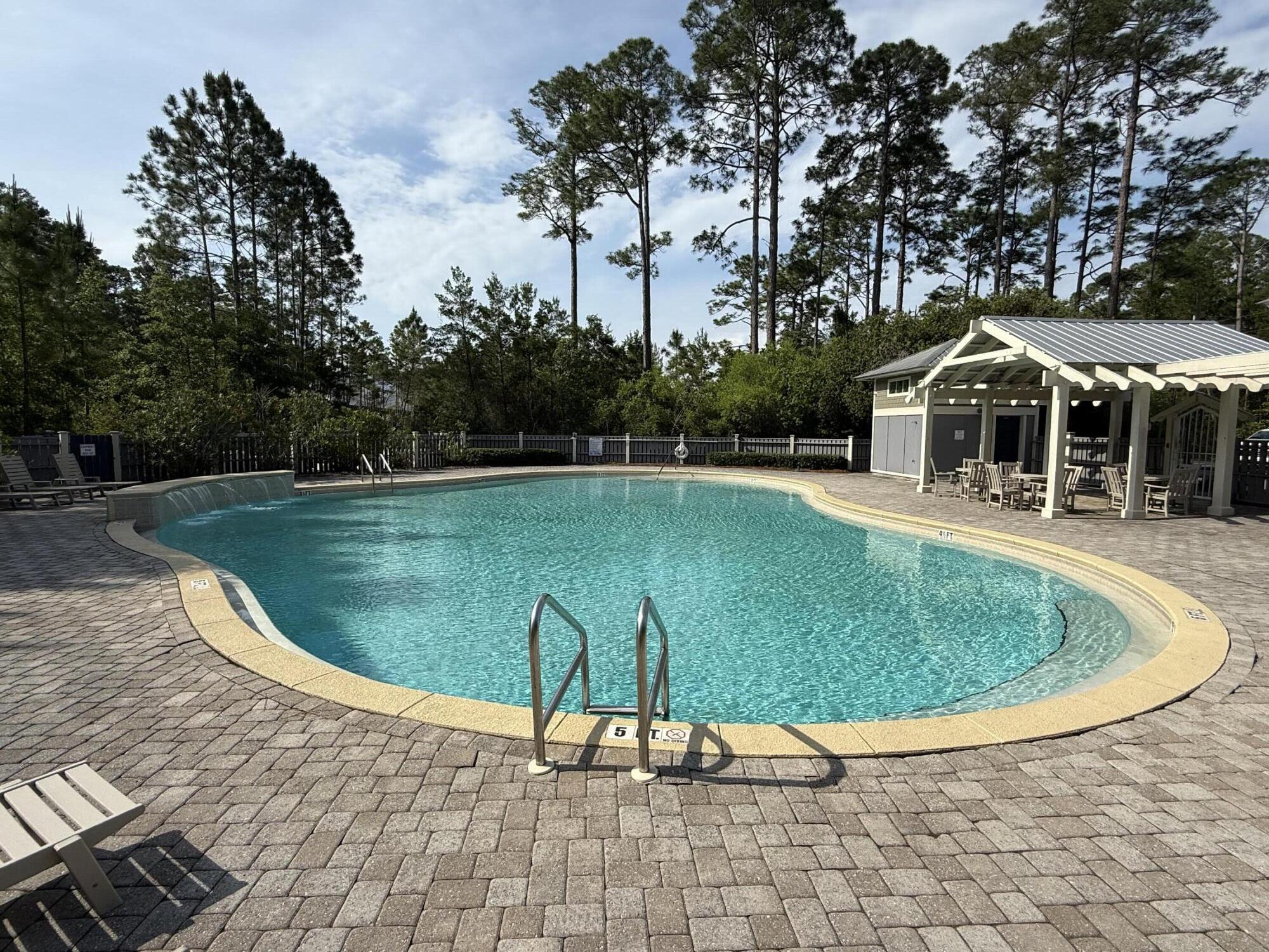 Lot 25 East Point Washington Road Santa Rosa Beach, FL 32459 - Photo 8 of 23 a view of a swimming pool with lawn chairs under an umbrella