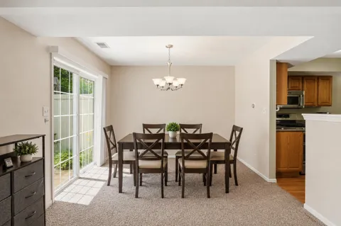 a view of a dining room with furniture and chandelier