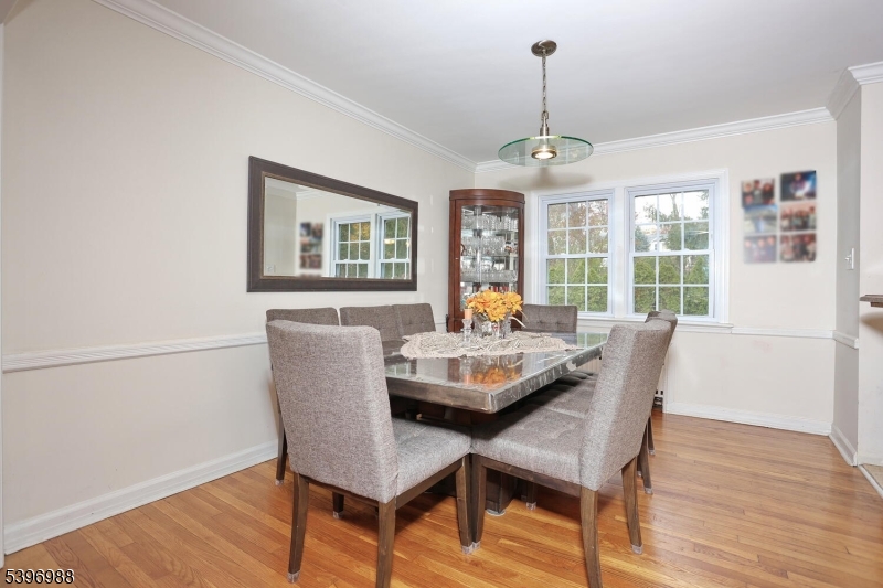 12 Pershing Avenue Ridgewood, NJ 07450 - Photo 17 of 42 a dining room with furniture a chandelier and wooden floor