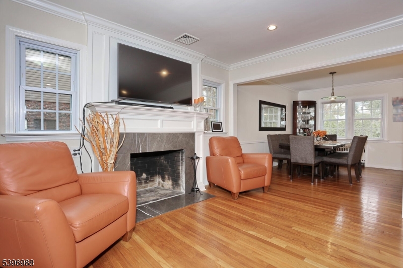 12 Pershing Avenue Ridgewood, NJ 07450 - Photo 18 of 42 a living room with furniture a flat screen tv and a fireplace