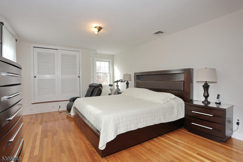 12 Pershing Avenue Ridgewood, NJ 07450 - Photo 20 of 42 a bedroom with a bed and wooden floor
