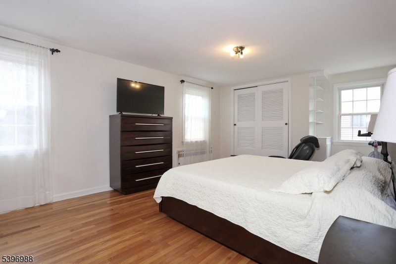 12 Pershing Avenue Ridgewood, NJ 07450 - Photo 21 of 42 a bedroom with a bed and wooden floor