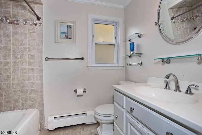 12 Pershing Avenue Ridgewood, NJ 07450 - Photo 23 of 42 a bathroom with a sink a toilet and a mirror