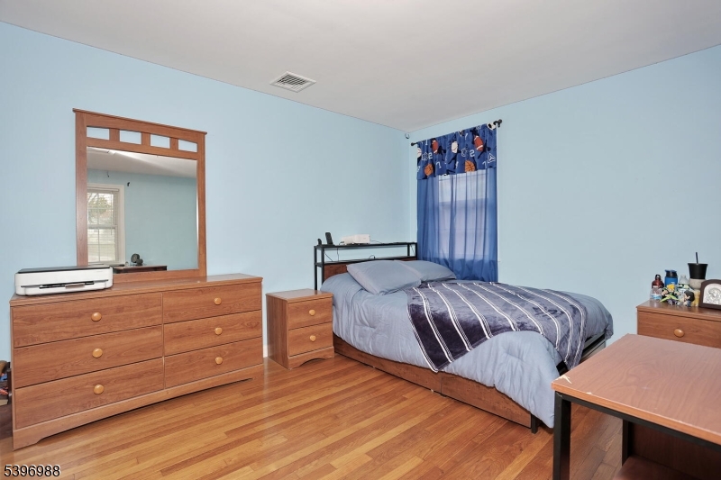 12 Pershing Avenue Ridgewood, NJ 07450 - Photo 28 of 42 a bedroom with a bed and dresser
