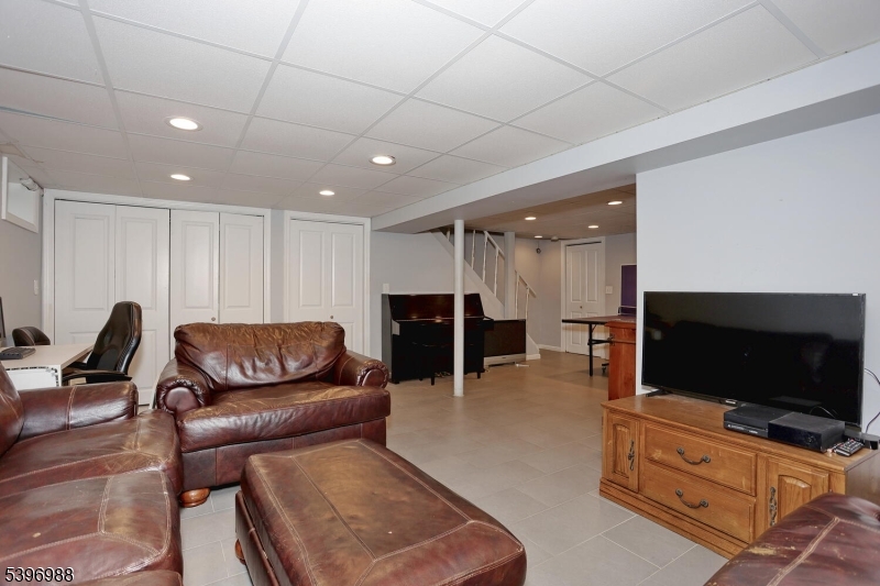12 Pershing Avenue Ridgewood, NJ 07450 - Photo 30 of 42 a living room with furniture and a flat screen tv