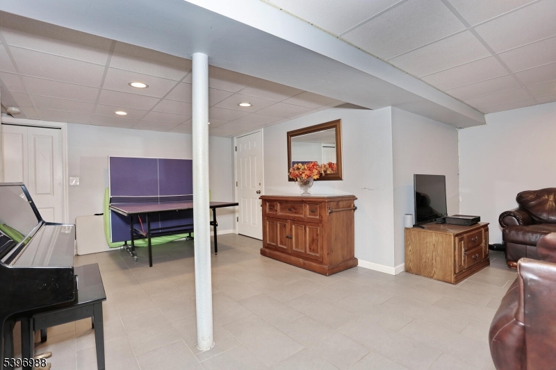 12 Pershing Avenue Ridgewood, NJ 07450 - Photo 32 of 42 a living room with furniture and a flat screen tv