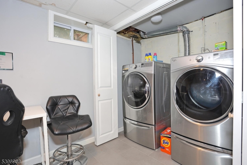 12 Pershing Avenue Ridgewood, NJ 07450 - Photo 33 of 42 a utility room with dryer washer and a view of kitchen