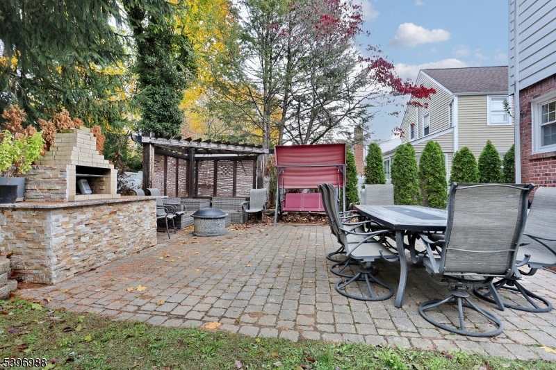 12 Pershing Avenue Ridgewood, NJ 07450 - Photo 37 of 42 a view of a patio with table and chairs with wooden fence and plants