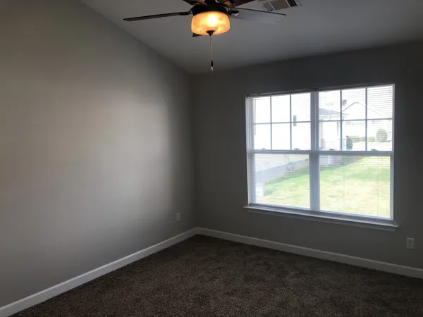 en view of a hallway with a chandelier fan