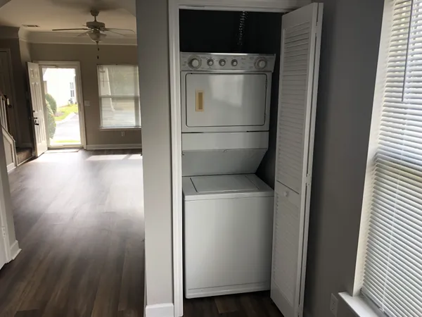 a view of kitchen and utility room with wooden floor