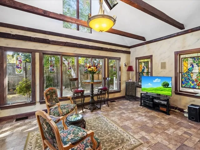 a living room with furniture and a floor to ceiling window