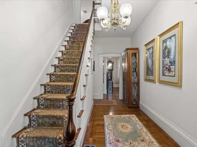 a view of an entryway with wooden floor
