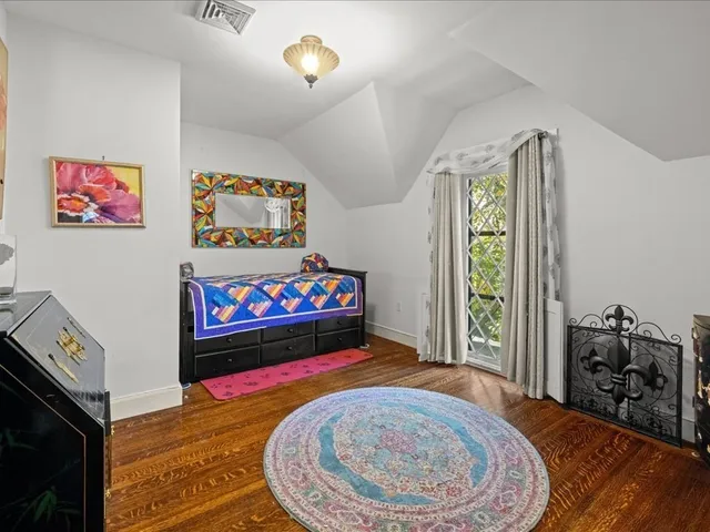 a bed room with a bed and a painting on the wall