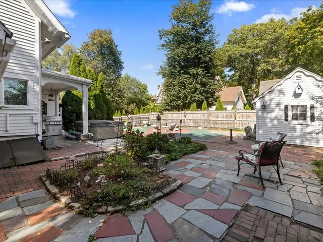 a view of a patio with table and chairs and potted plants