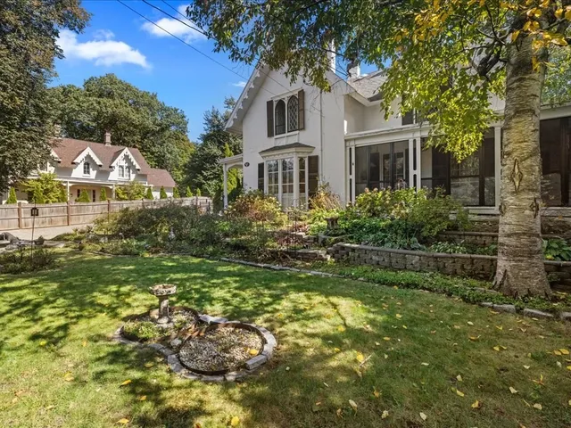 a front view of a house with a garden