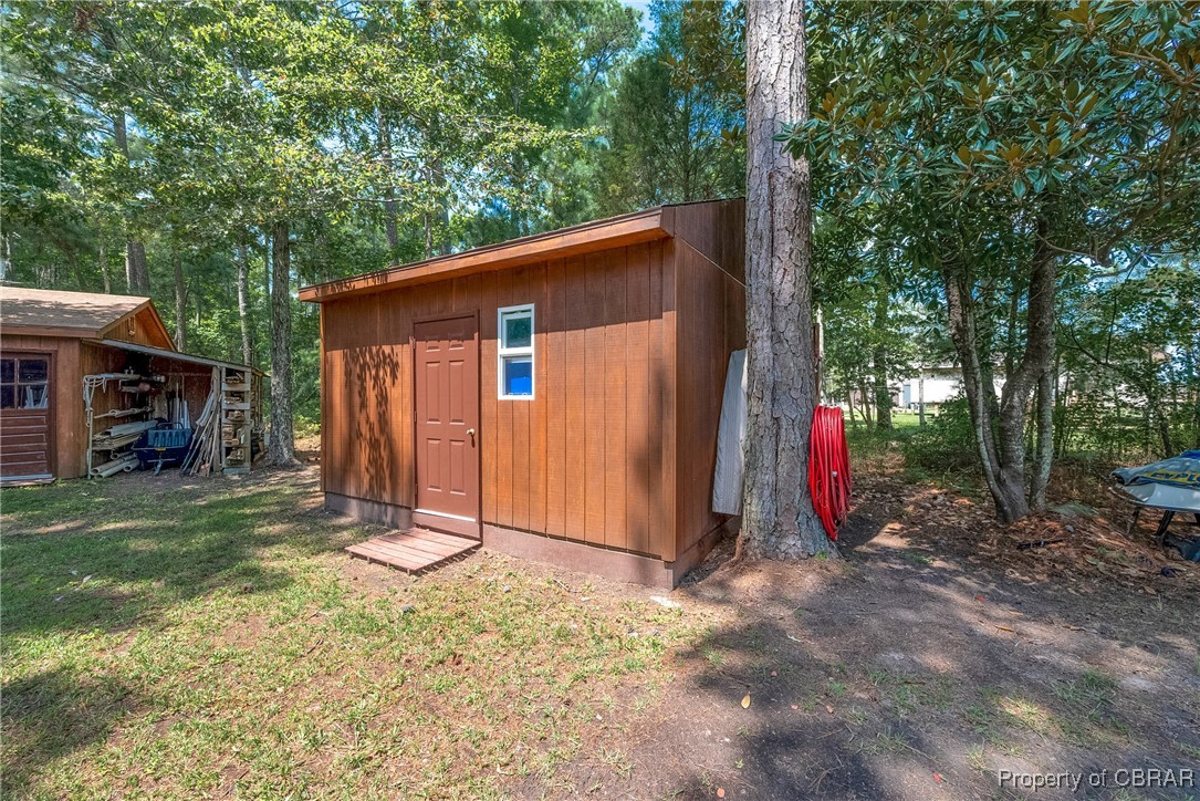 5447 Mobjack Road Gloucester, VA 23061 - Photo 25 of 40 View of outbuilding with a yard