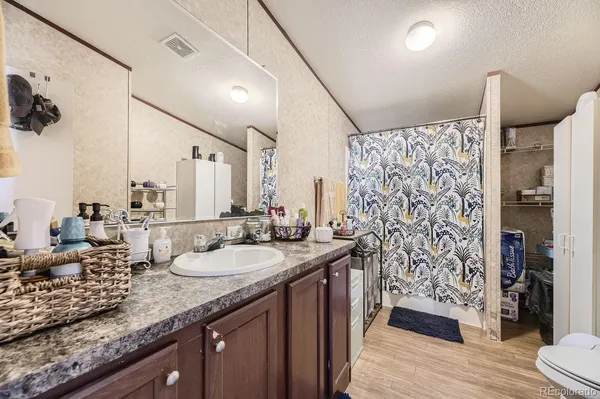 a bathroom with double vanity and a shower