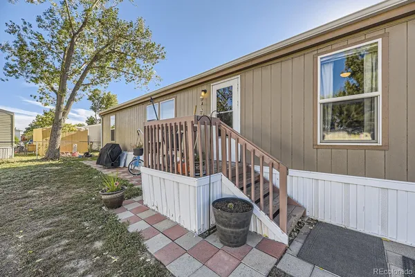 a view of a house with backyard and sitting area