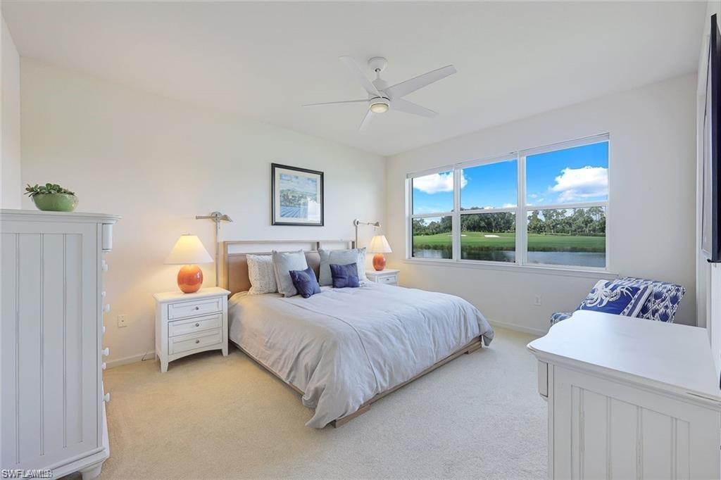 9525 Ironstone Terrace, Unit 102 Naples, FL 34120 - Photo 12 of 35 a bedroom with a bed and a window