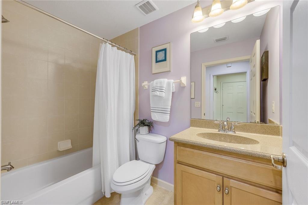 9525 Ironstone Terrace, Unit 102 Naples, FL 34120 - Photo 17 of 35 a bathroom with a sink toilet and shower