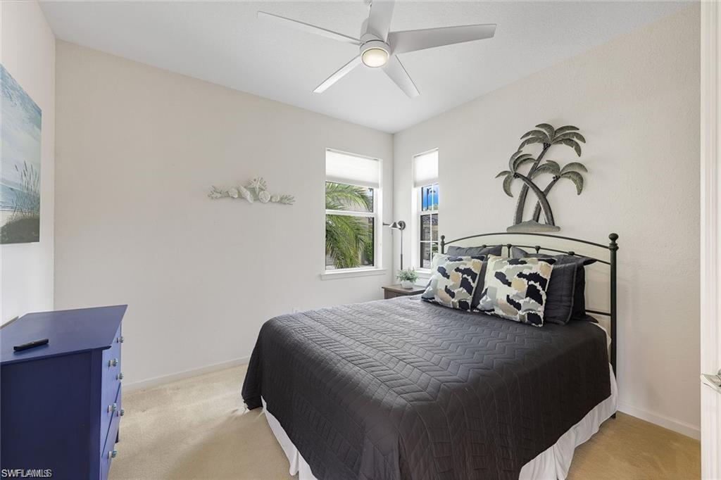 9525 Ironstone Terrace, Unit 102 Naples, FL 34120 - Photo 18 of 35 a bedroom with a bed and a window
